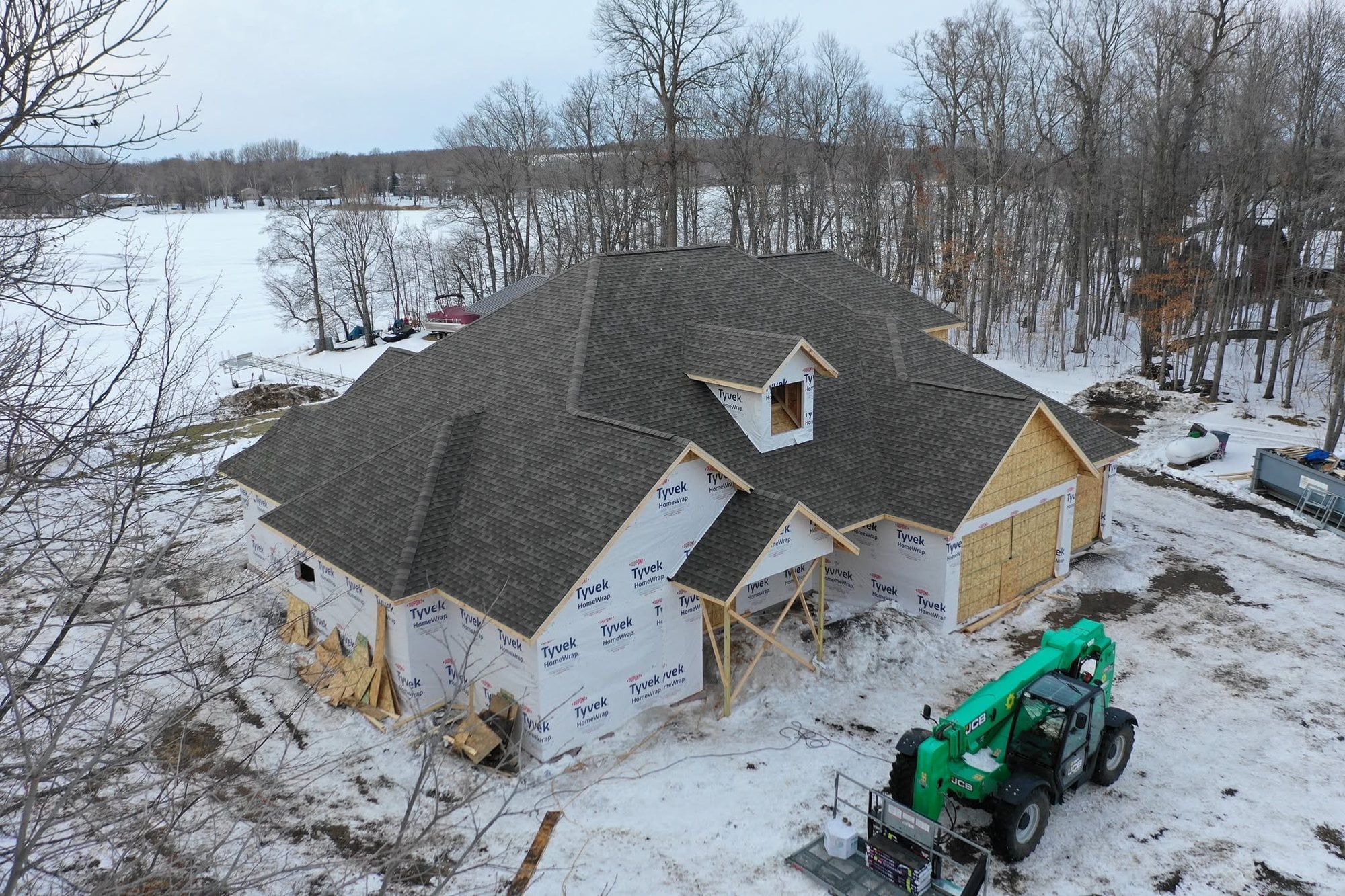 New charcoal roof on a custom lake home in winter